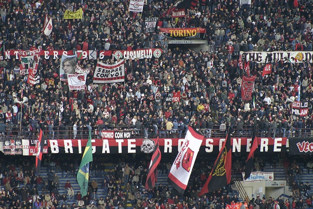 Italians supporting A.C. Milan at an Italian soccer match