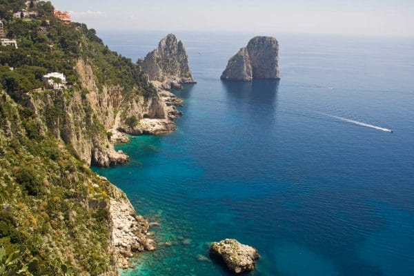 The Faraglioni in Capri (famous seaside rock formations). View of the coastline of the island of Capri, Amalfi Coast, Italy