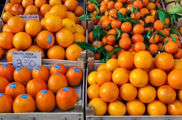 The Campo dei Fiori in Rome hosts an open-air food market that offers delicious food year round, like these persimmons and oranges in January! Photo by Marco Verch (flickr)