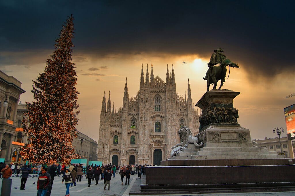 The Milan Duomo or cathedral from a distance with Christmas tree and horse statue