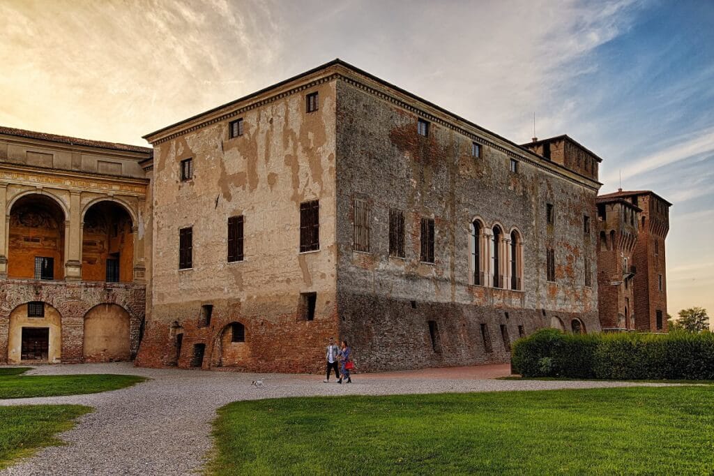 Historic, old stone building with path and grass in Mantua Italy