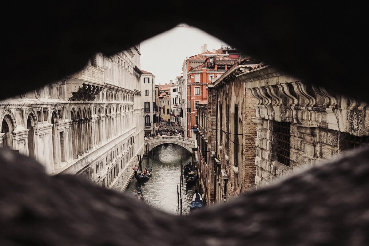 Venice slit through a peephole with bridge and canal in the background