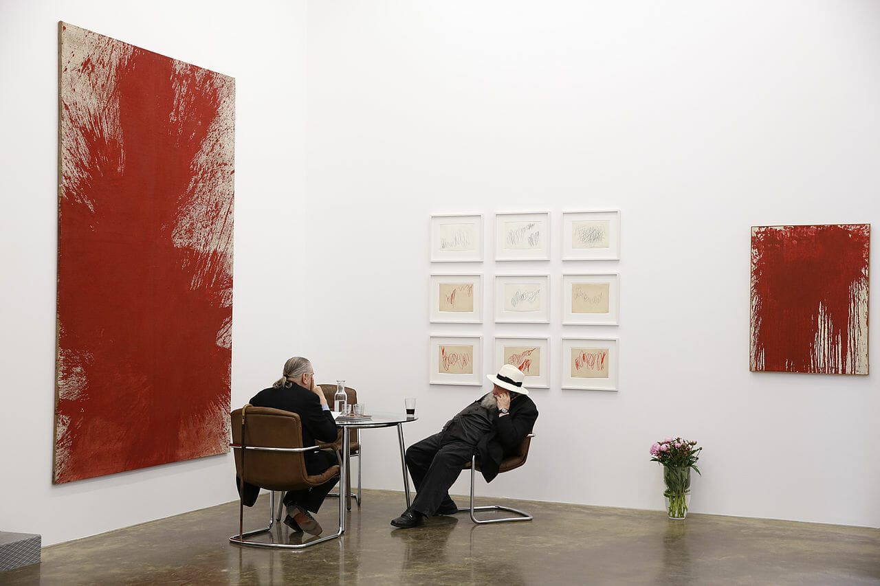 Hermann Nitsch being interviewed in front of his artwork at the Nitsch Foundation museum