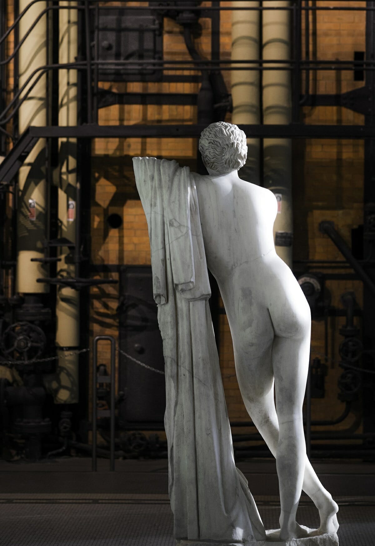 Statue from behind at the Centrale Montemartini museum in Rome.