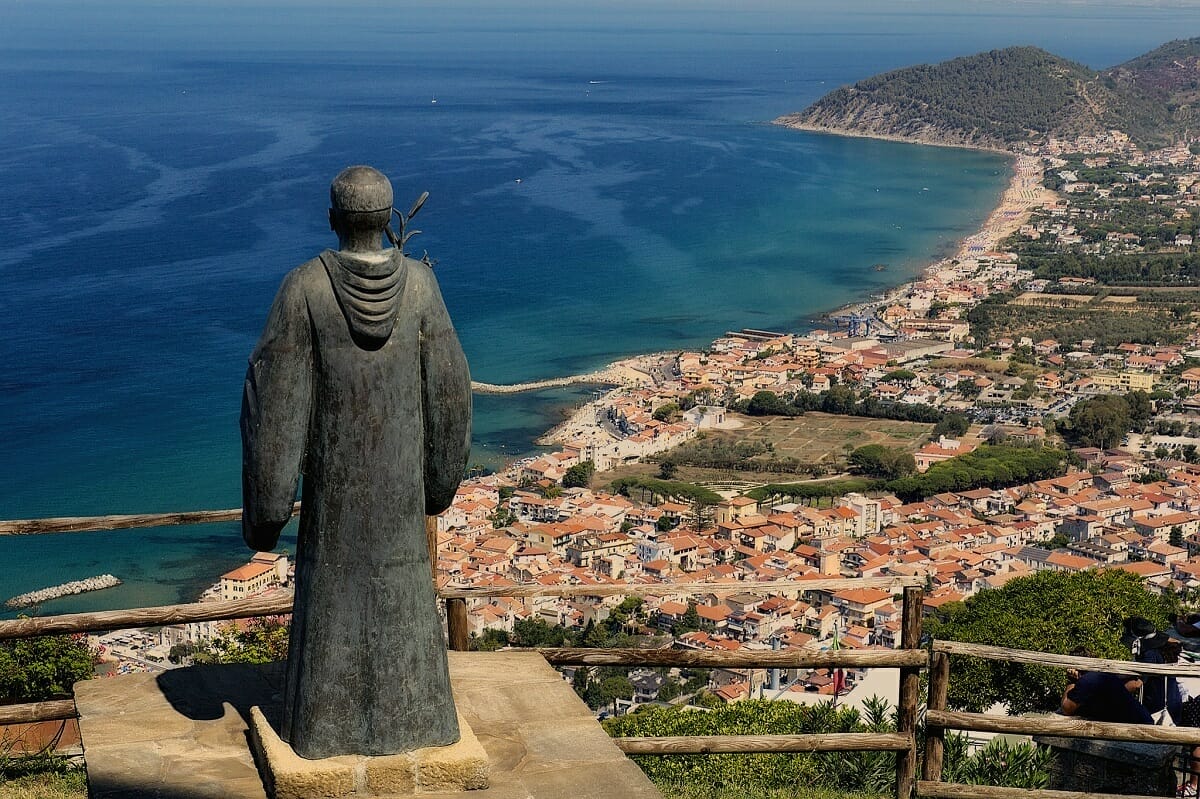 Castellabate view of Cilento coast with statue of monk and sweeping landscape