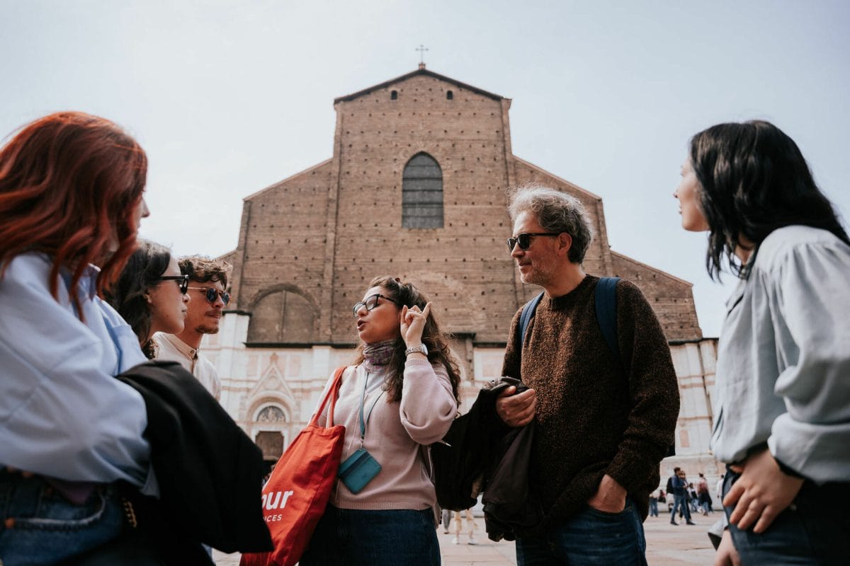 A Devour guide in Bologna leads guests in front of the church of Basilica di San Petronio, in Piazza Maggiore
