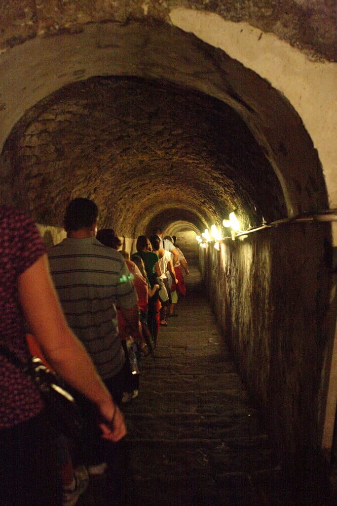 Group of tourists descending into Naples Underground cave