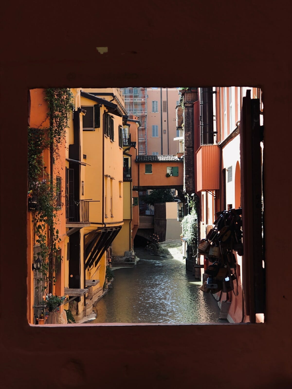 Tiny window looking out onto the canals in Bologna