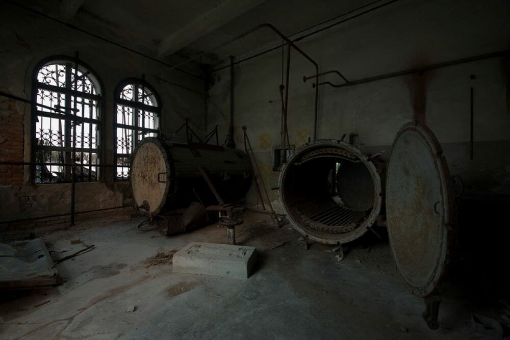 A view inside a building on Poveglia Island in Venice, displaying some abandoned machinery
