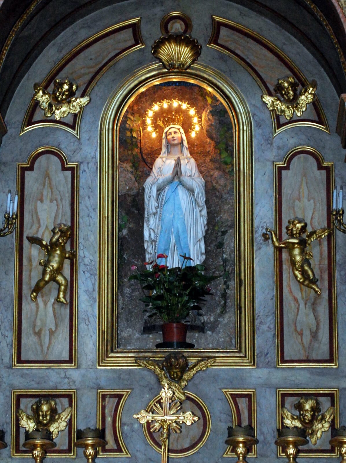 A statue of Mary praying inside of a church